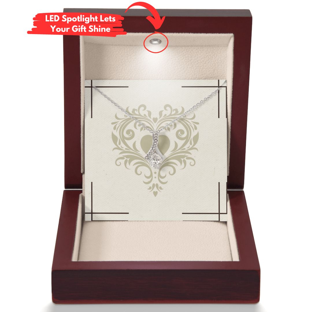 alluring beauty pendant and necklace shown in a mahagony style luxury box with an led light