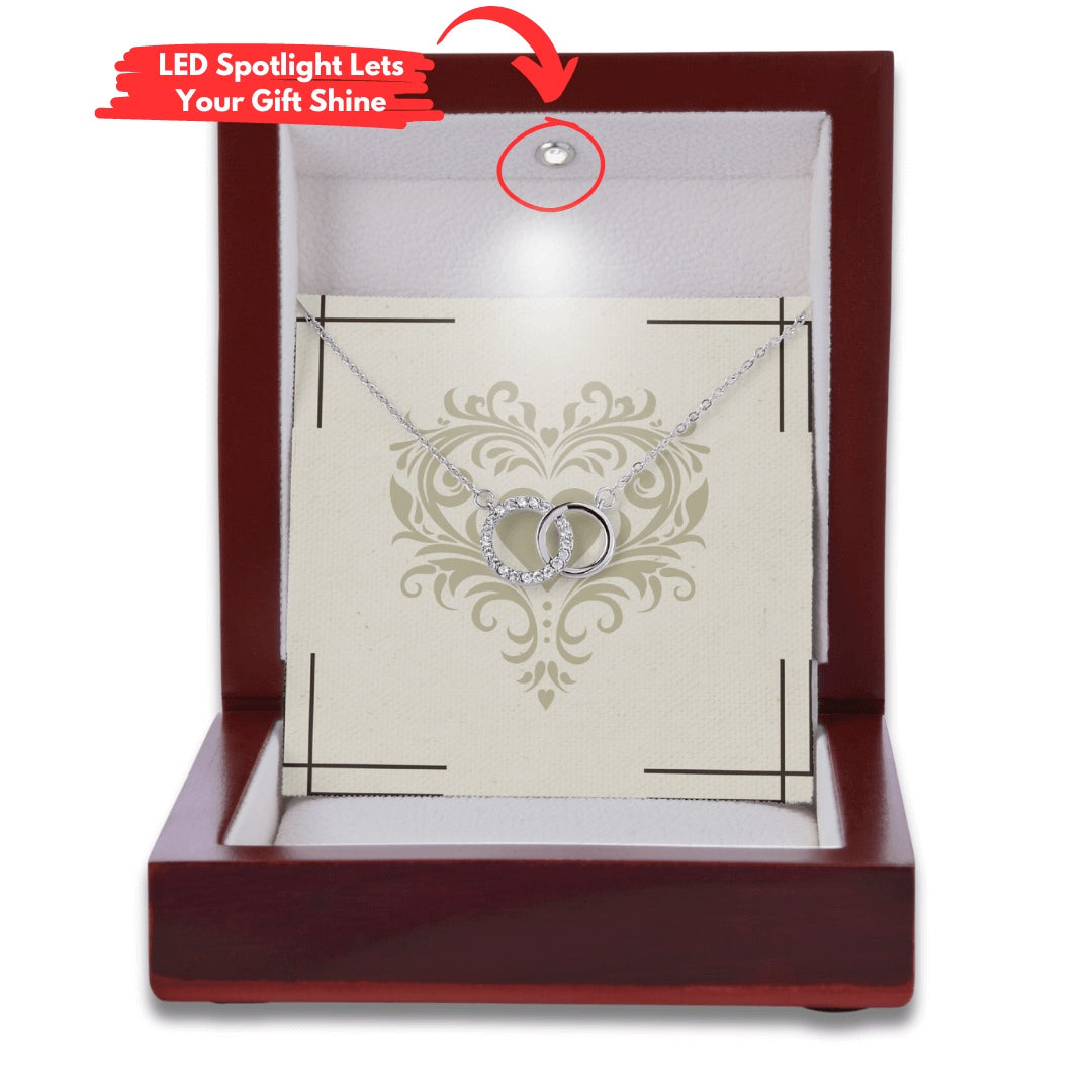 perfect pair necklace shown in a mahagony style luxury box with an led light